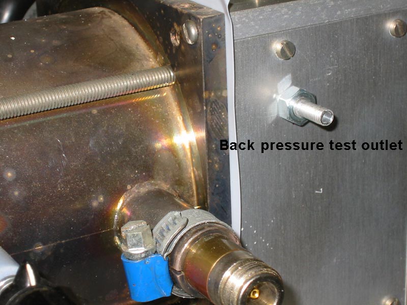 Back pressure test outlet